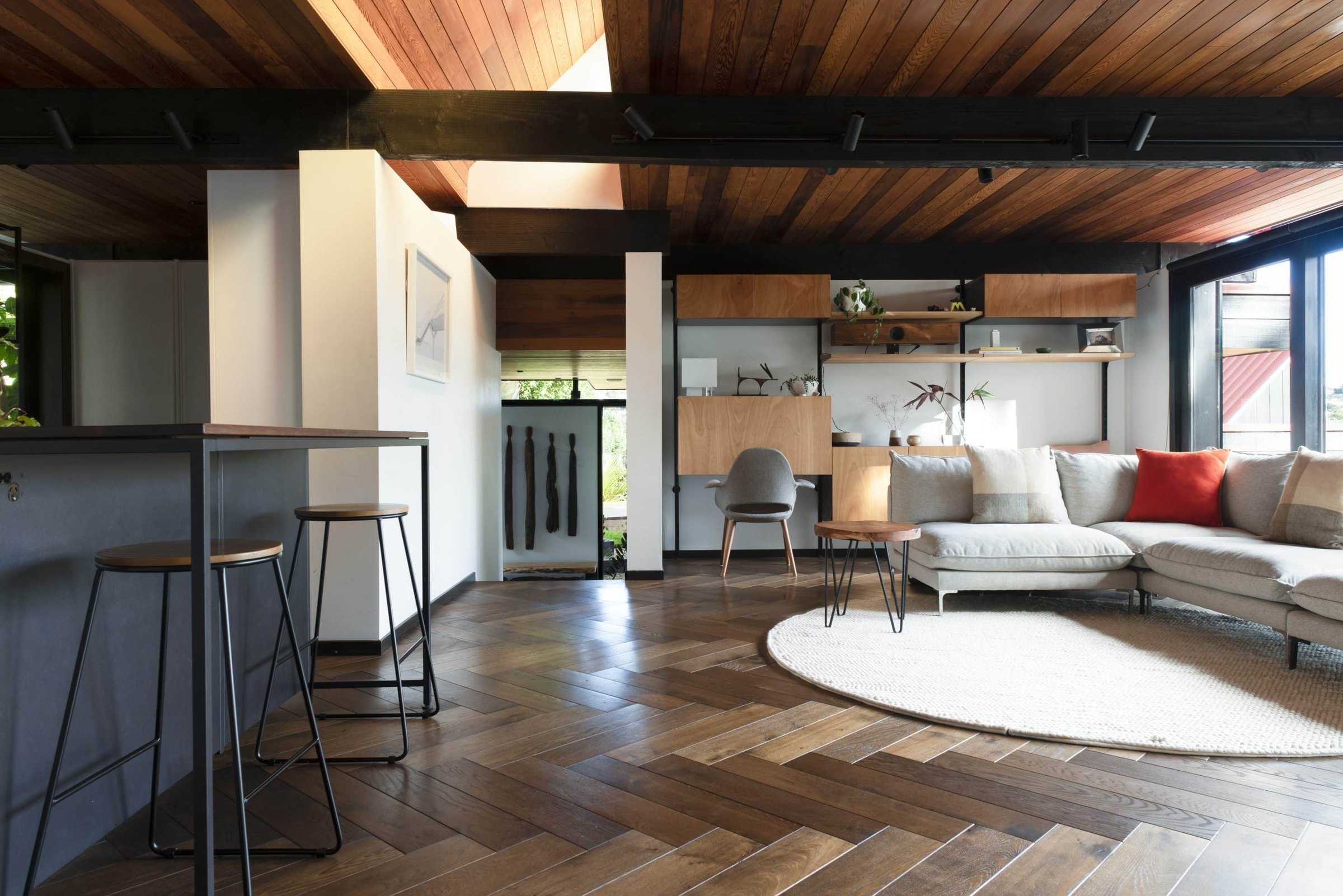 A herringbone timber floor in a room, an example of a finished wood floor.